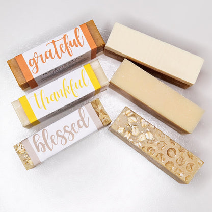 Three unlabeled soaps and three bar soaps labeled 'grateful', 'thankful', and 'blessed'. All against a white background.