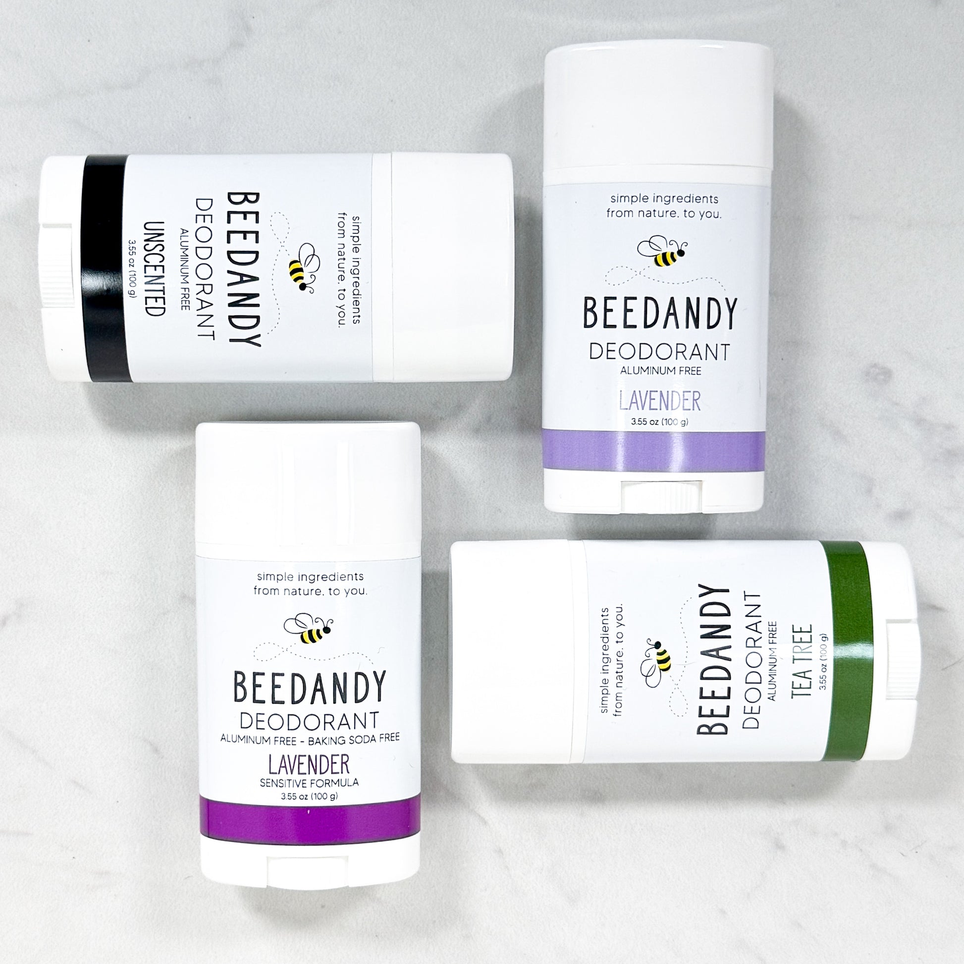 Beedandy aluminum-free deodorant sticks in assorted scents displayed on a light background.