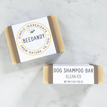 two bars of Klean K9 dog shampoo against a white marble background