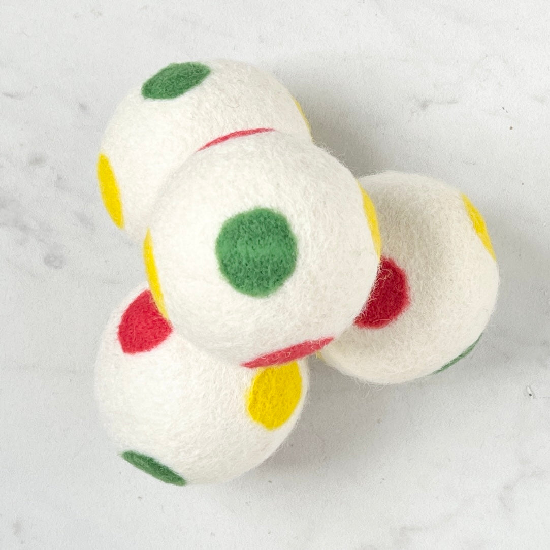 set of 4 white dryer balls with multi colored dots, on white background