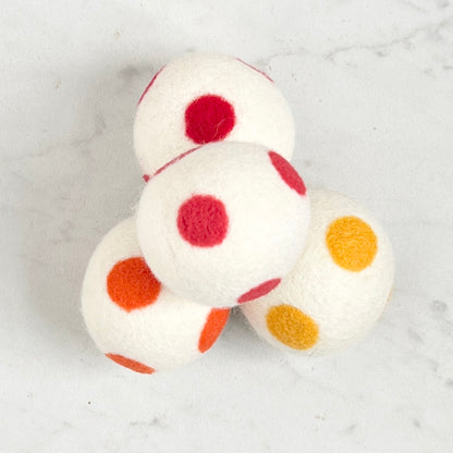 set of 4 white dryer balls with colored dots, on white background