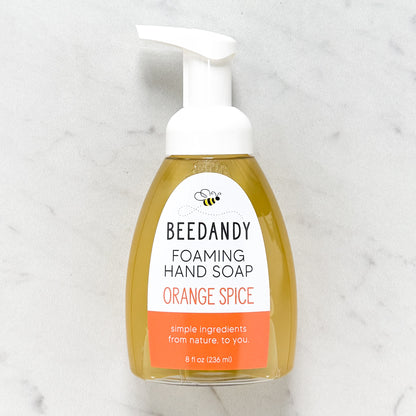Beedandy orange spice foaming hand soap in a clear pump bottle with white dispenser on a light background.