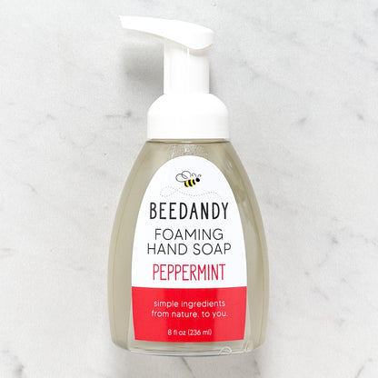 Beedandy peppermint foaming hand soap in a clear pump bottle with white dispenser on a light background.