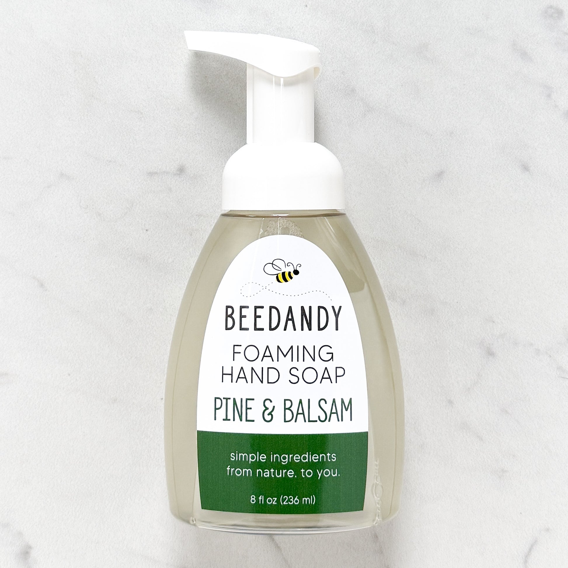 Beedandy pine and balsam foaming hand soap in a clear pump bottle with white dispenser on a light background.