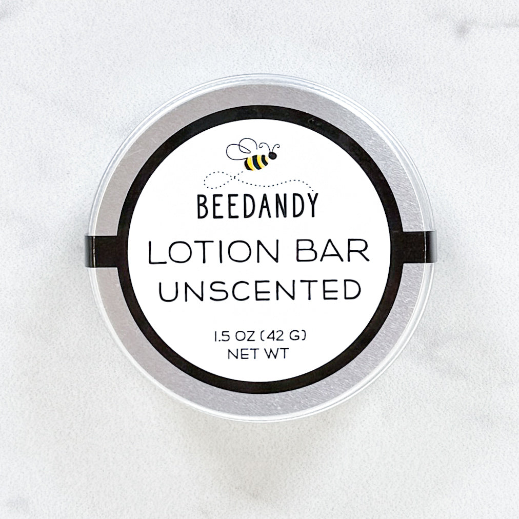 A metal tin of BEEDANDY unscented lotion bar on a white background.