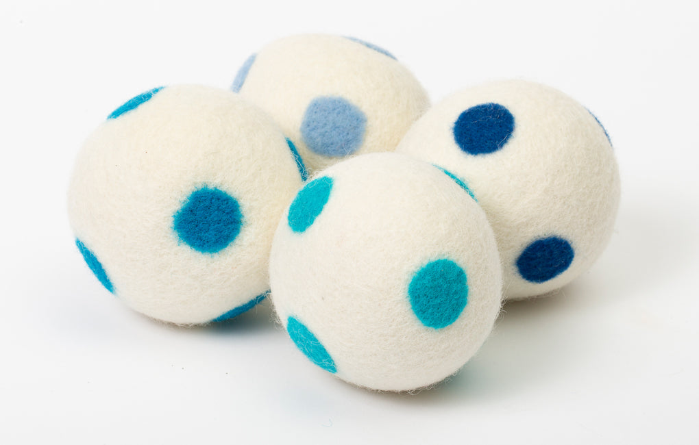 set of 4 white dryer balls with blue dots, on white background