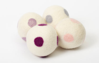 set of 4 white dryer balls with purple dots, on white background